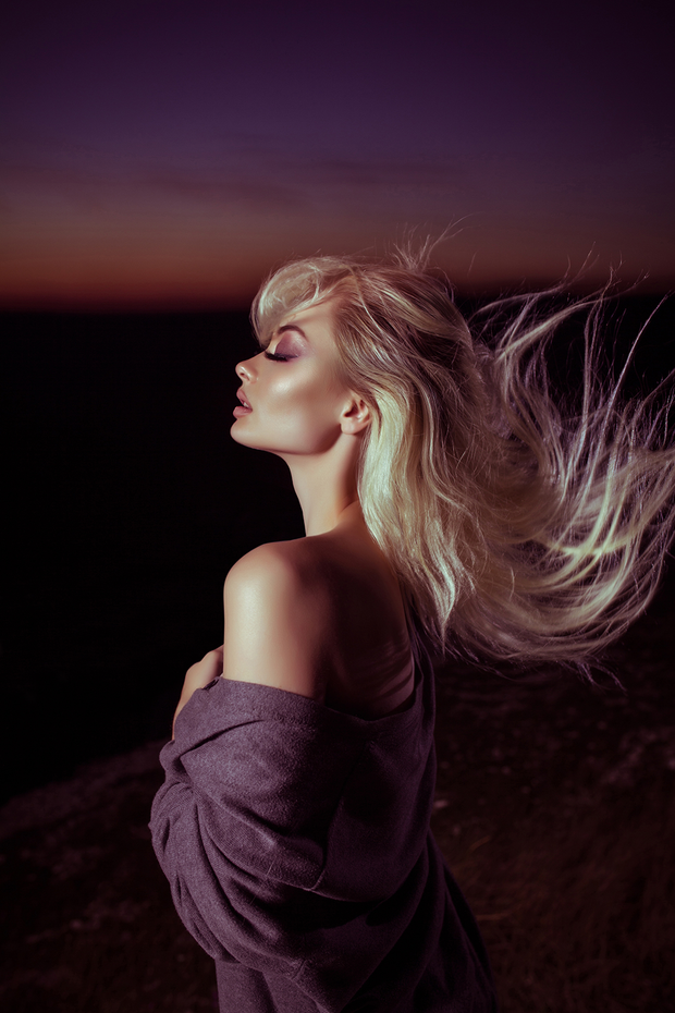 Beautiful blond woman bathed in moon glow highlighter